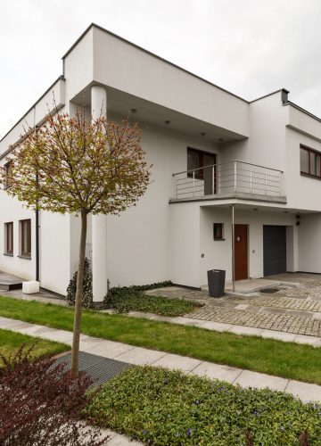 White mansion in new style with garden, exterior view